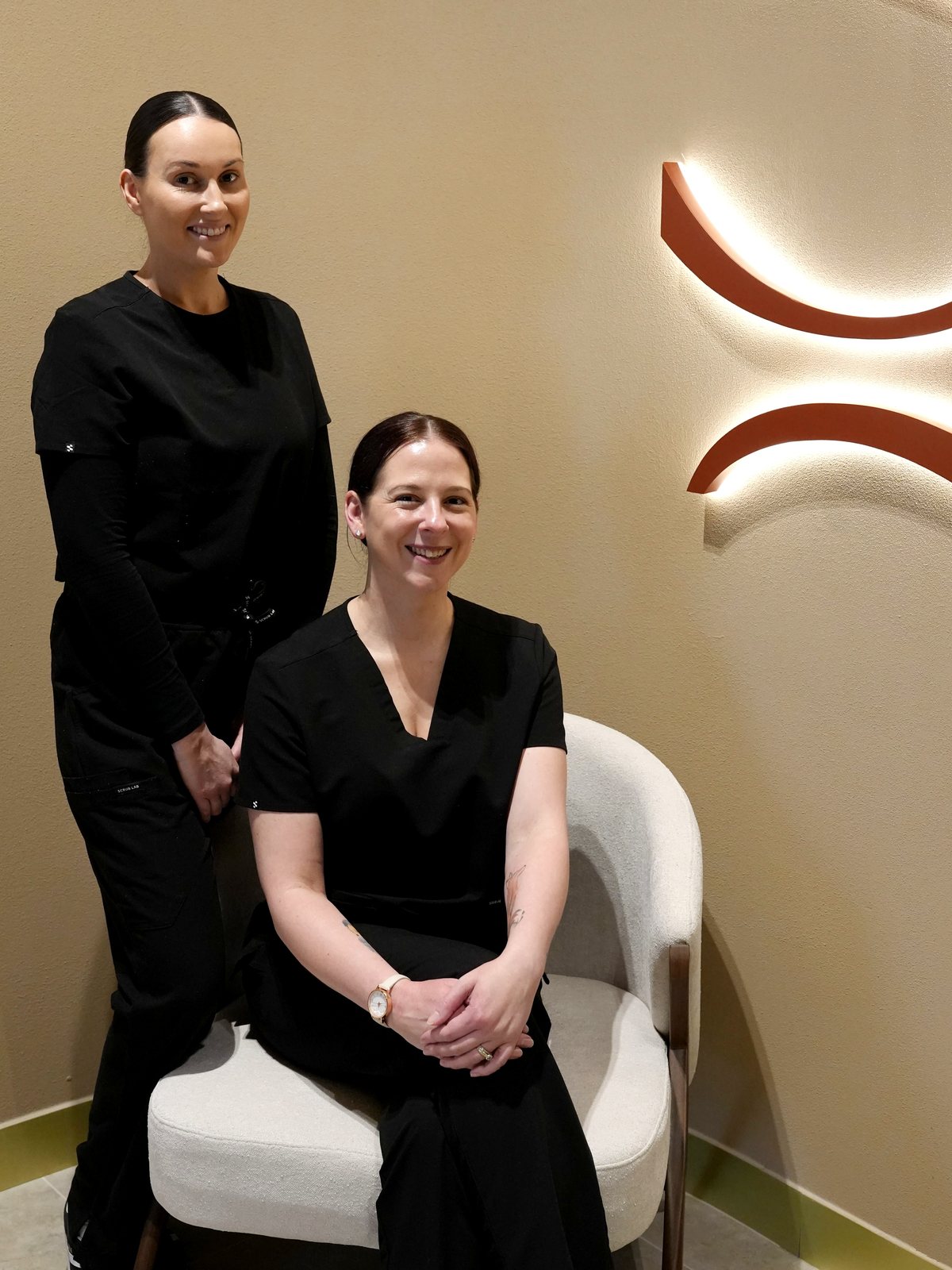 Rhianna and Melissa of Mind Body & Soul Aesthetic Clinic in the clinic's Noosa reception